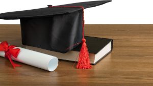 graduate cap and a folded diploma