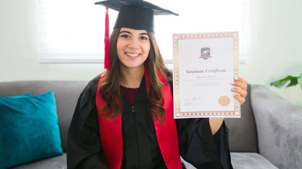 a graduate holding college degree certificate